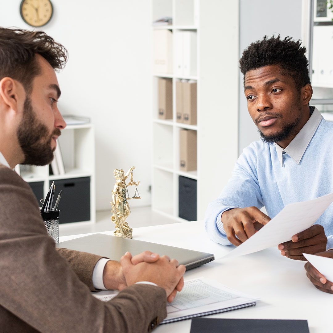 Attorney with client signing a document